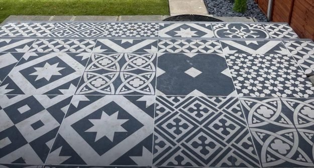 Patterned floor tiles laid on a garden patio by M + G Property Solutions