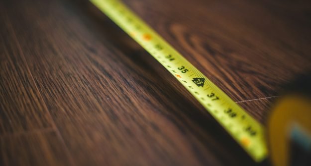 Measuring tape and timber ready for a flooring job